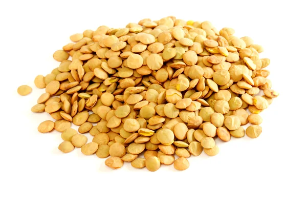 Brown lentils scattered on white background — Stock Photo, Image