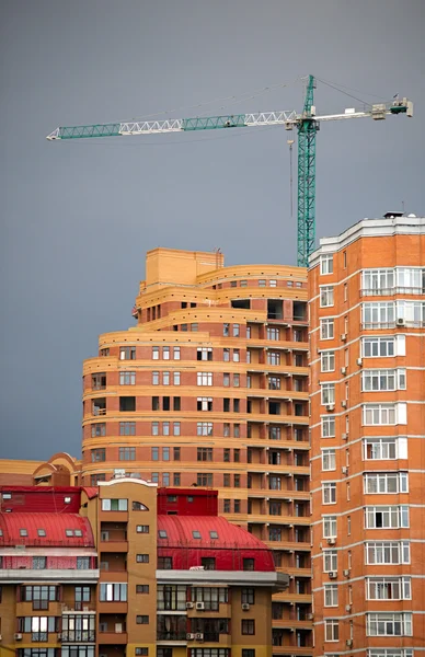 stock image Abstract of multi apartments building and crane in a sunset