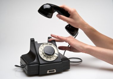 Vintage telephone being picked up clipart