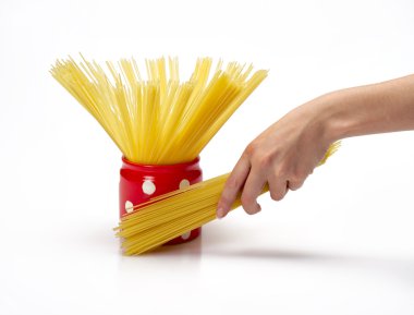 Woman's hands holding red jar with spaghetti inside clipart