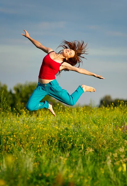 Woman jumping on a sunset — Stock Photo, Image