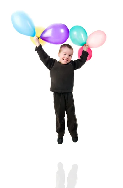 Menino bonito com o salto de balão — Fotografia de Stock