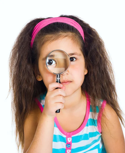 Little girl looking through a magnifier — Stock Photo, Image