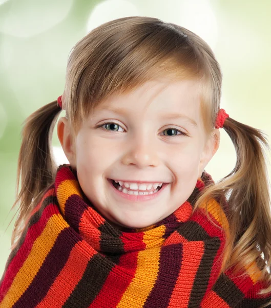 Little girl in striped scarf — Stock Photo, Image