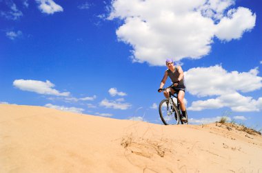 Young men riding a bike clipart