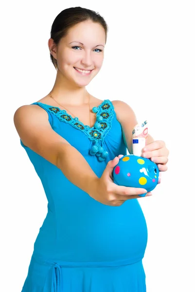 Беременная женщина держит копилку — стоковое фото