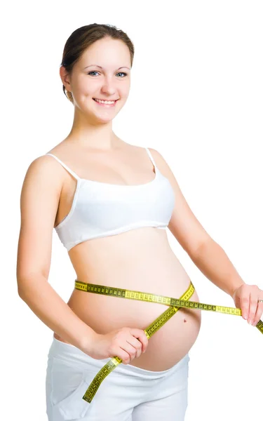 Vackra gravid kvinna mäter magen — Stockfoto