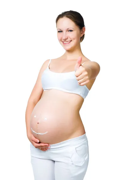 Donna incinta con crema cosmetica sulla pancia — Foto Stock