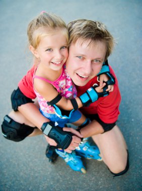 Dad with his daughter on the skates clipart