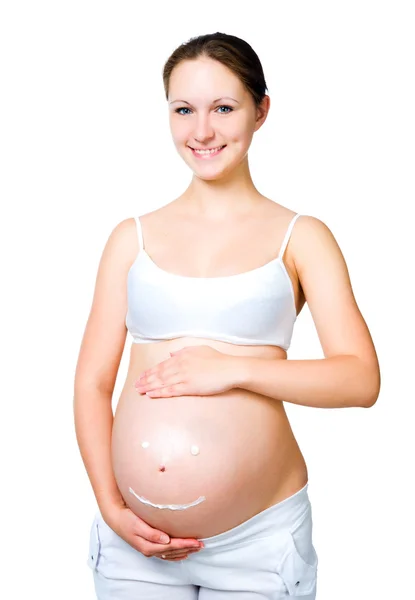 Gravid kvinna med kosmetiska grädde på magen — Stockfoto