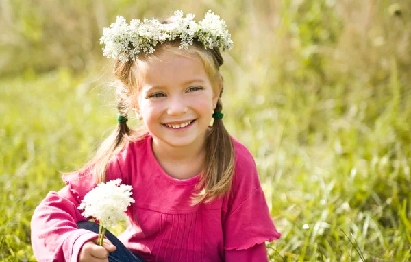 Маленькая девочка в венке из цветов — стоковое фото