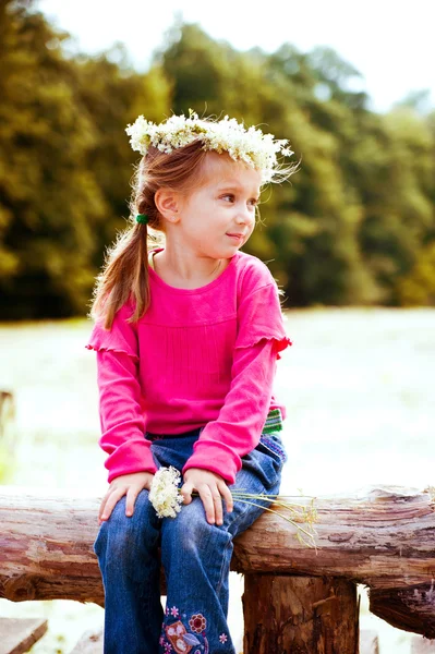 Little girl in wreath of flowers — Stock Photo, Image