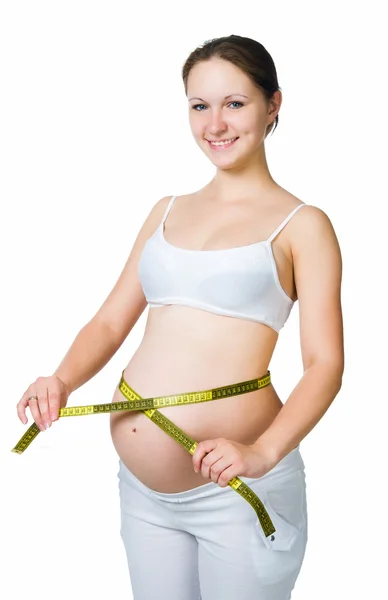 Vackra gravid kvinna mäter magen Stockfoto