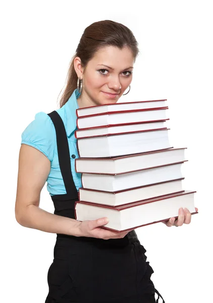 Estudante bonito está segurando um monte de livros — Fotografia de Stock
