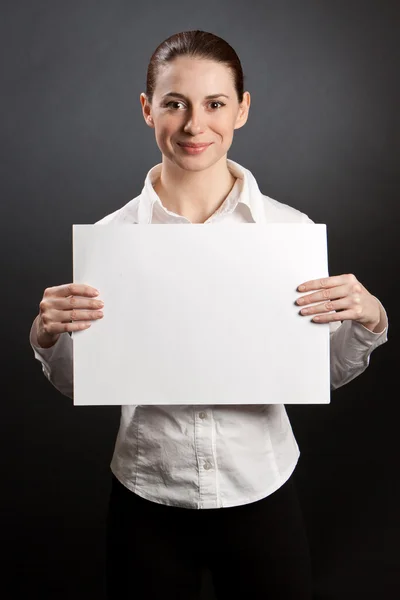 Pretty woman holding white poster — Stock Photo, Image