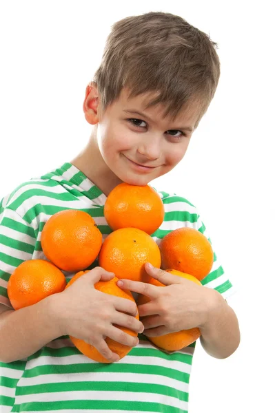 Jongen bedrijf sinaasappelen — Stockfoto
