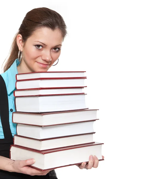 Hermosa estudiante está sosteniendo un montón de libros —  Fotos de Stock