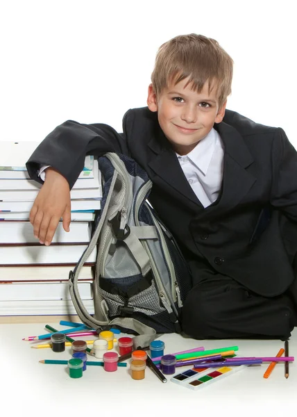Pojke, pennor, färger och böcker — Stockfoto