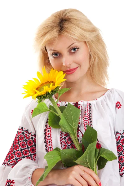 Woman wears Ukrainian dress is holding a sunflower — Stock Photo, Image