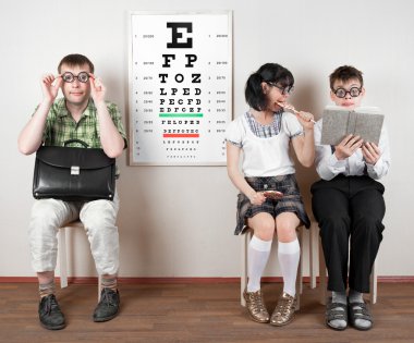 Three person wearing spectacles in an office at the doctor clipart