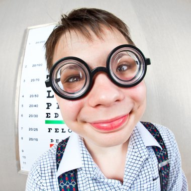 Person wearing spectacles in an office at the doctor clipart