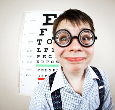 Person wearing spectacles in an office at the doctor clipart