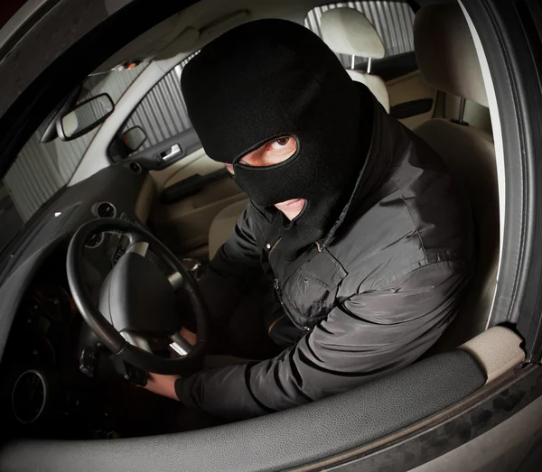 Robber and the thief in a mask hijacks the car — Stock Photo, Image