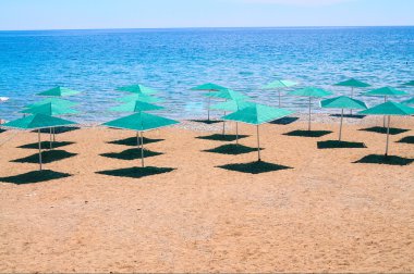 Beach and parasols in Turkey seaside. clipart