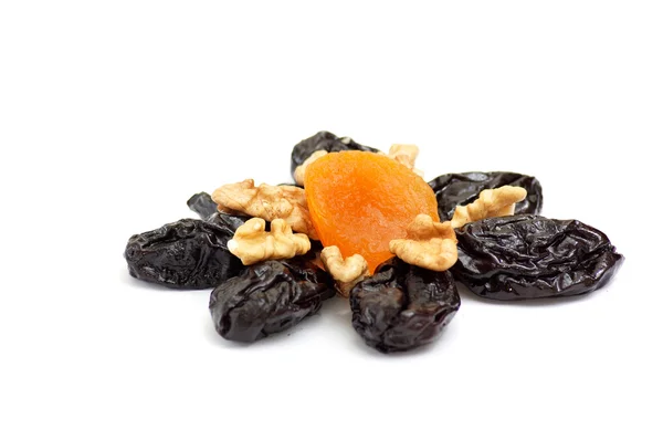 Dried apricot,walnuts and prunes on a white. — Stock Photo, Image