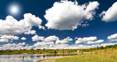 Wonderful view lake and autumnal meadow. clipart