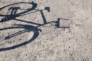 Abandoned bike and shadow from it. clipart