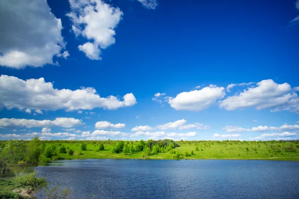 Panorama von See, Wiese und blauem Himmel. — Stockfoto