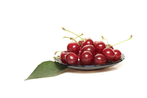 Plate and cherries on a white. — Stock Photo, Image
