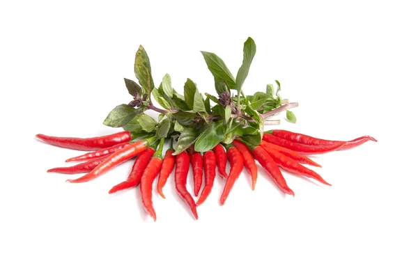 Green basil and ripe peppers on a white. — Stock Photo, Image