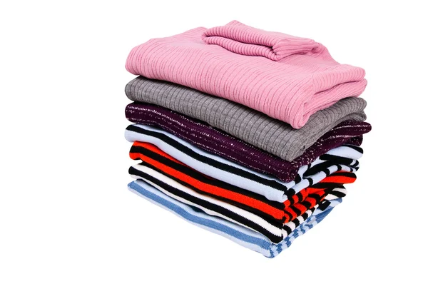 Stack of colorful winter sweaters isolated on a white. — Stock Photo, Image