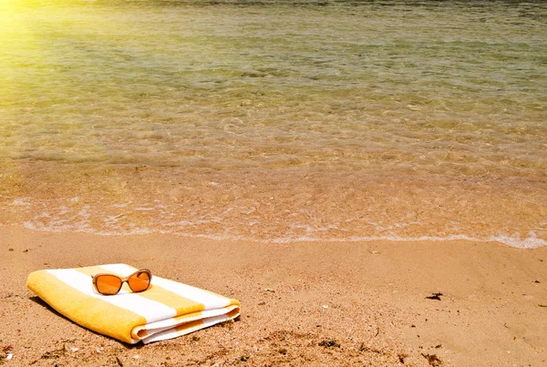 Бирюзовое море, очки и полотенце . — стоковое фото