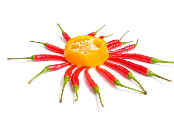 One half and several whole peppers on a white. — Stock Photo, Image