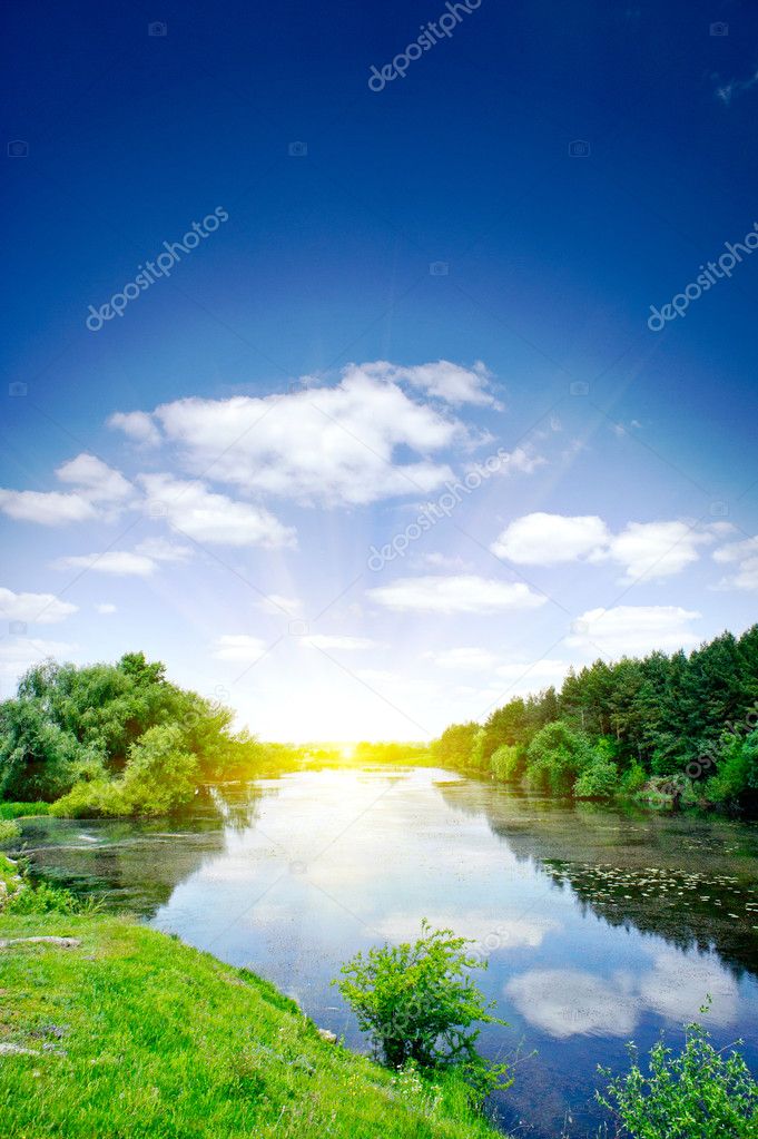 Small river , sun and blue sky.