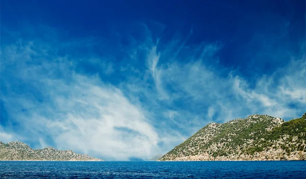 Mavi gökyüzünde bulutlar ve muhteşem deniz. — Stok fotoğraf
