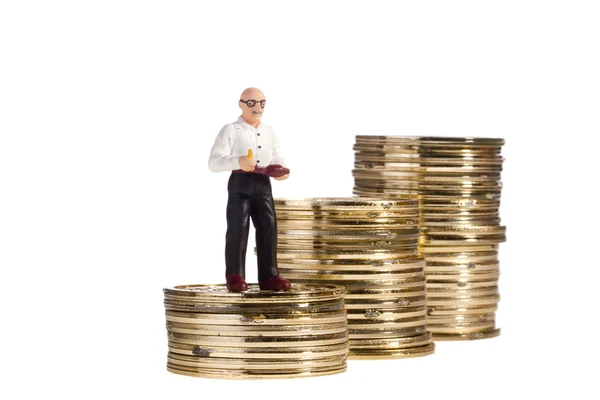 Uomo anziano giocattolo e monete — Foto Stock