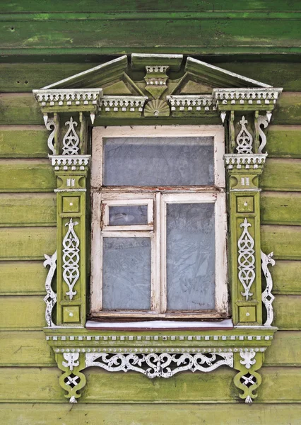 Old wooden window, decorated with carving — Stock Photo, Image