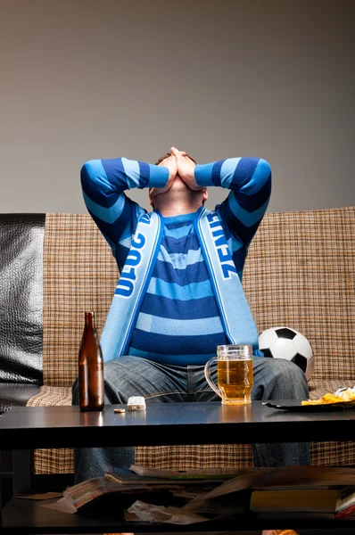 Soccer fan on sofa — Stock Photo, Image