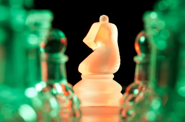 Red and green glass chess pieces — Stock Photo, Image