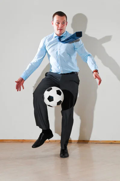 Businessman is playing football — Stock Photo, Image