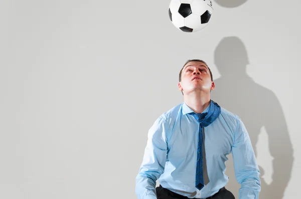 Businessman is playing football — Stock Photo, Image