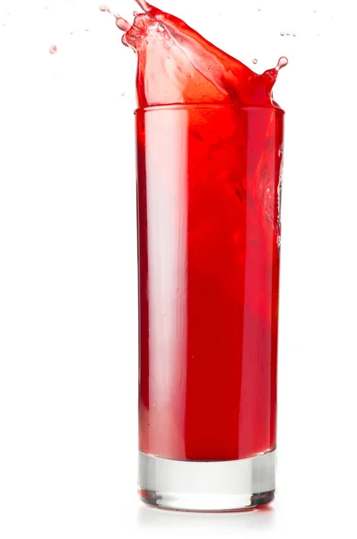 Red liquid is spalsing in glass — Stock Photo, Image