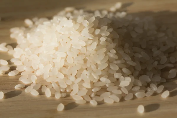 Rice on wooden board — Stock Photo, Image
