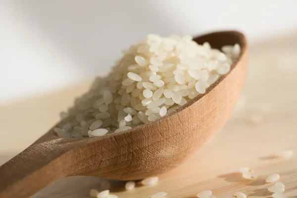 stock image Rice grains in a wooden spoon