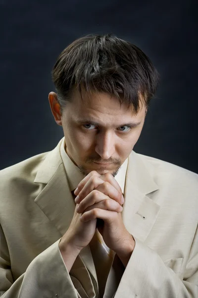 stock image Young man in a suit, praying for something