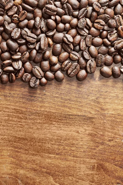 Coffee beans on wood — Stock Photo, Image